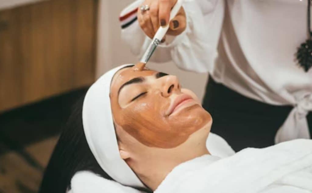 A woman getting a facial done.