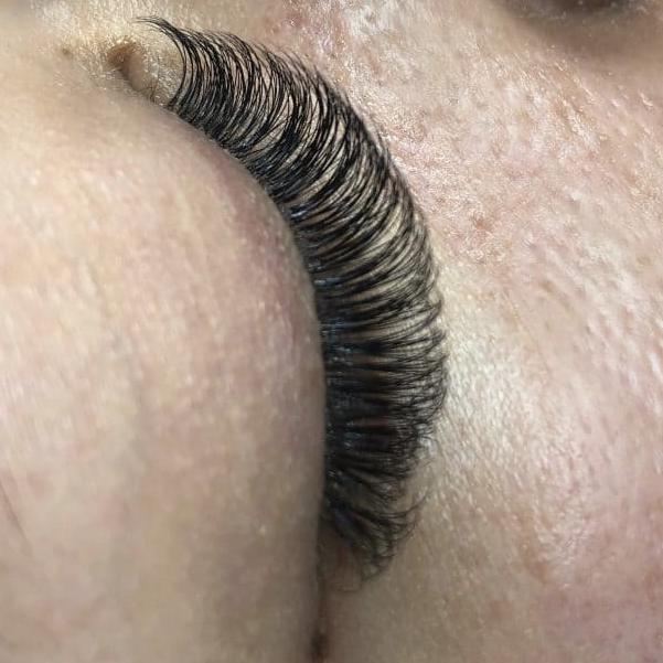 A woman maintaining her lash extensions.