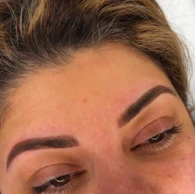 A woman after getting permanent makeup services.