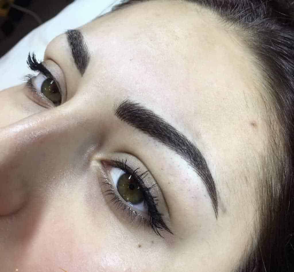 Close-up of perfectly shaped permanent makeup brows